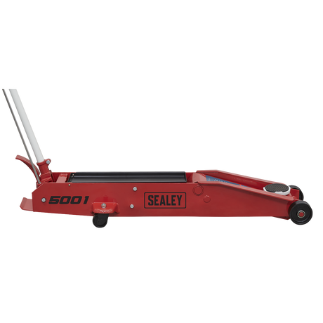 A Sealey Trolley Jack 5 Tonne Long Reach - 5001 in red, featuring a long handle, small wheels, and a foot pedal.