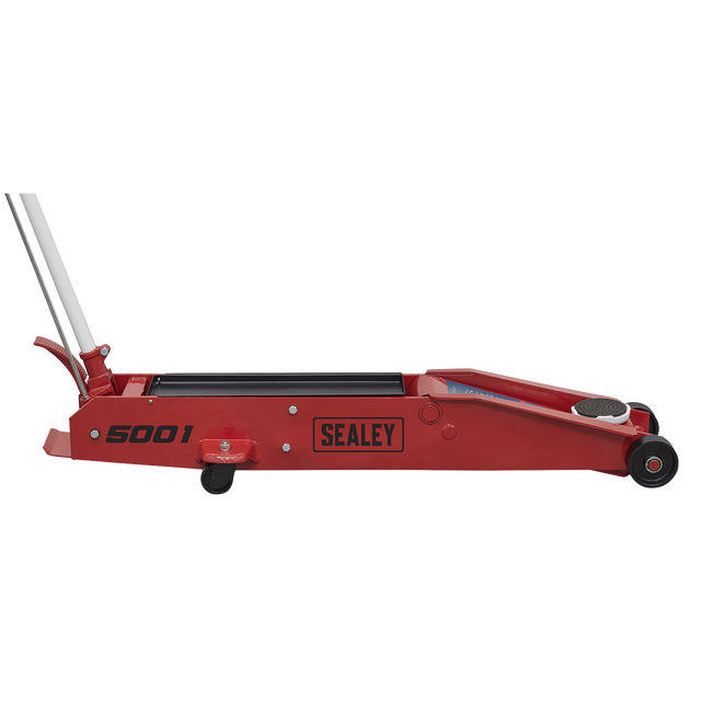 A Sealey Trolley Jack 5 Tonne Long Reach - 5001 in red, featuring a long handle, small wheels, and a foot pedal.