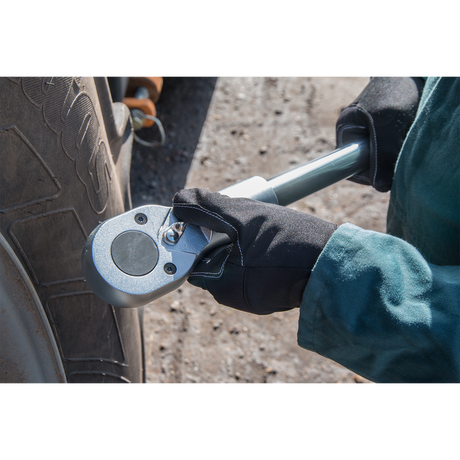 A person using the Sealey Socket Set 22pc 1"Sq Drive 6pt WallDrive® Metric - AK261 to tighten a bolt on a vehicle tire.