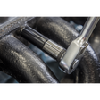 A Sealey Socket Set Deep 13pc 1/2"Sq Drive Metric - Black Series (AK7995) with a Chrome Vanadium steel socket is tightening a bolt on a mechanical component surrounded by textured dark metal, offering a lifetime guarantee for reliable performance.