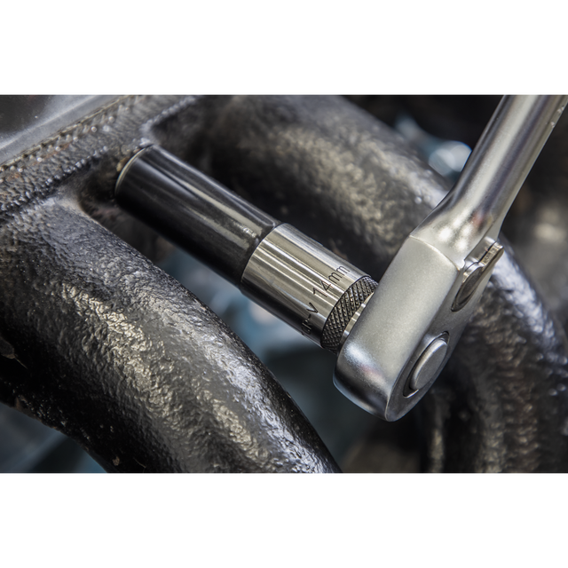 A Sealey Socket Set Deep 13pc 1/2"Sq Drive Metric - Black Series (AK7995) with a Chrome Vanadium steel socket is tightening a bolt on a mechanical component surrounded by textured dark metal, offering a lifetime guarantee for reliable performance.