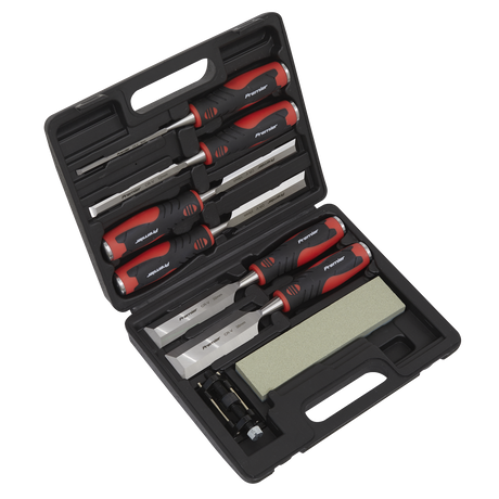 A Sealey Hammer-Thru Wood Chisel 8pc Set - AK9240, complete with red and black handles, along with a sharpening stone and other small tools, is displayed in a sleek black carrying case.