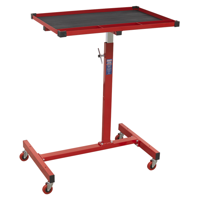 The Sealey Mobile Work Station - Adjustable-Height - AP200 features a red adjustable-height tool tray with a rectangular black surface, supported by a metal frame with four castor wheels, two of which have brakes.