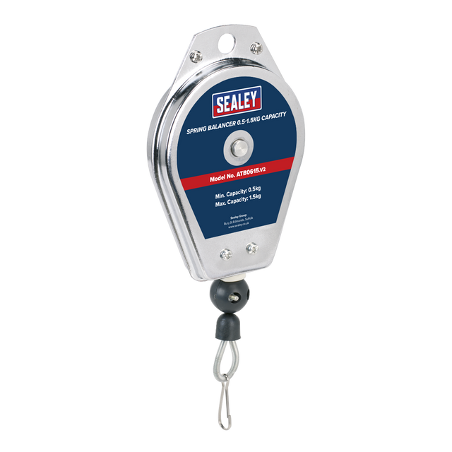 A Sealey Spring Balancer, model number ATB0615 with a 0.5-1.5kg capacity, features a metal casing and multi-strand steel cable to ensure durability. Equipped with a bottom hook and a label displaying specifications, it provides excellent tool support to reduce operator fatigue during use.