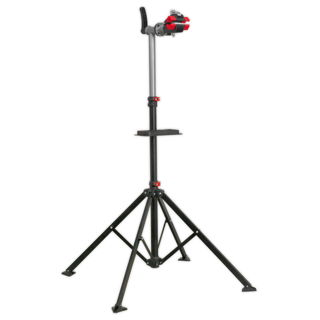 Introducing the Sealey Workshop Bicycle Stand - BS103: a heavy-duty bicycle stand with an adjustable work height. It features a sleek black tripod design and red knobs for securing equipment, along with a rubber-coated frame clamp and a stable base with three extendable legs.