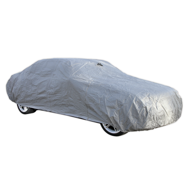 The Sealey Car Cover X-Large 4830 x 1780 x 1220mm - CCXL, crafted from anti-scratch material, is draped over a car, completely hiding its make and model while offering superior weather protection.