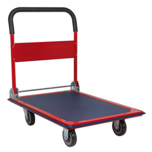 The Sealey Platform Truck 300kg Capacity - CST992 features a red and black design with a four-wheel configuration, a rubberised deck for a non-slip surface, and a foldable handle. It is ideal for warehouse applications.