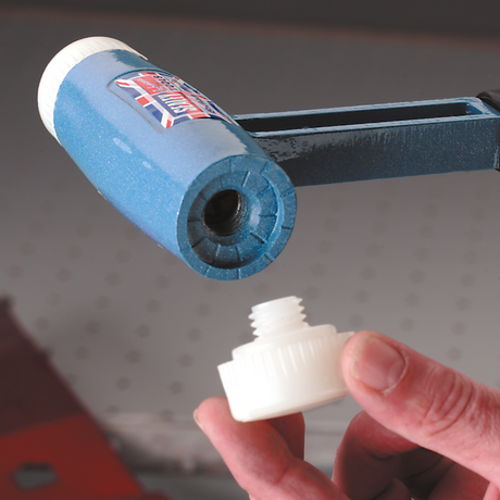 A hand is holding a white plastic threaded component beneath a blue cylindrical tool with a similar thread, both appearing to be parts of the Nylon Hammer Face, Extra Hard/Yellow for DBHN275 - 342/716AF by Sealey, typically seen in professional use.