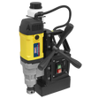 The Sealey Magnetic Drilling Machine 35mm 110V - MAG110V features a high-quality yellow and black build, complete with a control panel that has green and red buttons, two black handles for easy operation, and a coiled power cord for convenience.