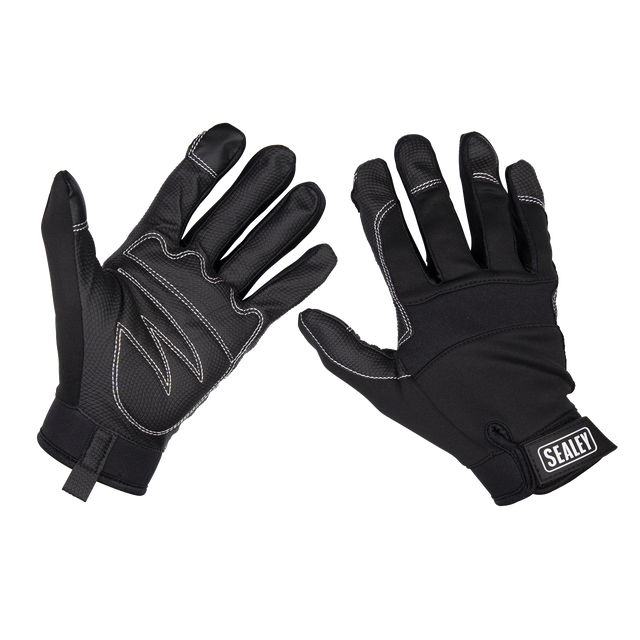 Two black touchscreen gloves with white stitching and a small 'Sealey' logo on the wrist of one glove, displayed with palms and backs visible. The anti-slip palms ensure precision control in various tasks. The product is the Mechanic's Gloves Light Palm Tactouch - Large (MG798L) by Sealey.