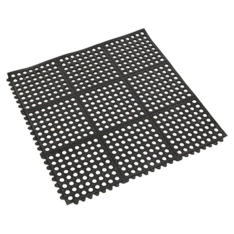 The Sealey Interlocking Anti-Fatigue Matting 920 x 920mm - MIC9292 is a black rubber mat designed with circular holes in a grid pattern. It features scalloped edges and offers flexibility and durability, providing excellent relief from fatigue.