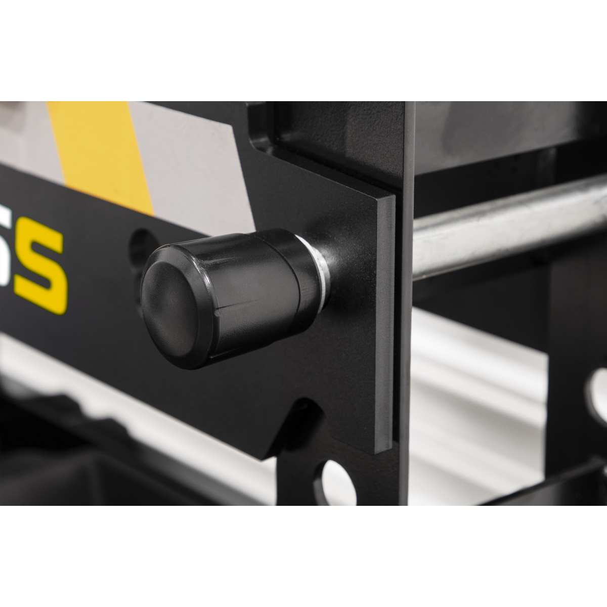 Close-up of a black knob on the Viking Hydraulic Press 15 tonne Bench Type - PPB15S by Sealey, with part of a yellow, black, and white design visible, attached to a heavy-duty steel frame.