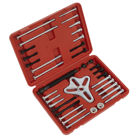 A red plastic storage case from Sealey, containing the Harmonic Balancer Puller Set 49pc - PS979, includes bolts, rods, and a three-pronged pulling device for extracting flywheels. The case is open to display the neatly organized tools.