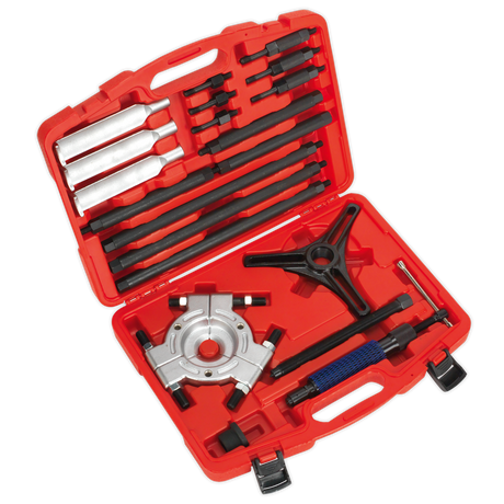 A red tool case from Sealey, the Hydraulic Bearing Separator/Puller - PS9821, featuring an assortment of black and silver steel tools such as a gear puller set, chisels, and other hand tools arranged in designated slots.