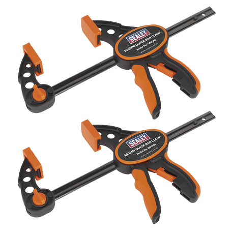 Two Sealey Quick Bar Clamp 150mm clamps, part of the QBC1502 two-piece set, are displayed against a white background. The heavy-duty clamps feature black and orange handles and are designed for quick one-handed operation. They are positioned parallel to each other, showcasing both front and side views.