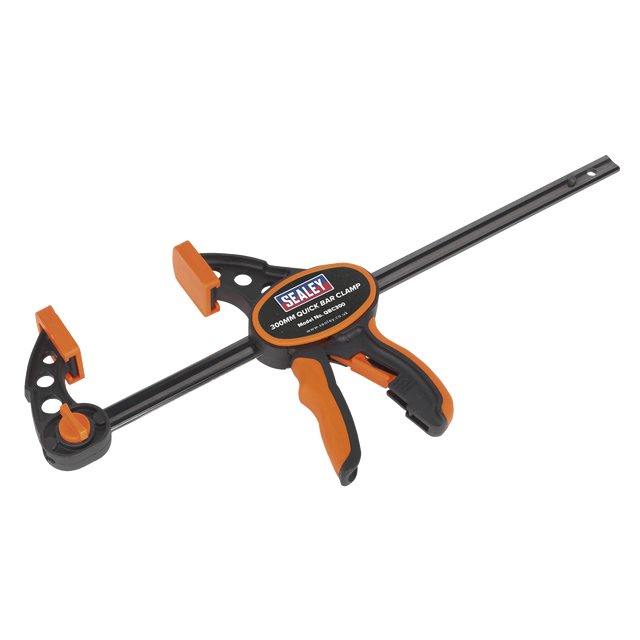 The "Sealey Quick Bar Clamp 300mm - QBC300" is a heavy-duty clamp with a carbon steel bar and a textured TPR grip handle in orange and black.