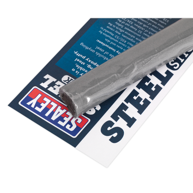 A steel welding rod resting atop Sealey's Quick-Set Metal Putty 114g - SCS390 packaging, ideal for use alongside steel reinforced epoxy putty for robust metal repairs.