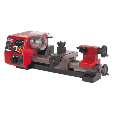 The Sealey Metalworking Mini Lathe 250mm - SM2503A is a red and black bench-mounted miniature lathe machine featuring various adjustment knobs, a high-torque motor, variable speed control, and a clear protective shield.