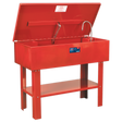 The Sealey Parts Cleaning Tank - SM40 is a red metal washer featuring an open lid, a cleaning nozzle, and a front label. It boasts a large capacity tank and is supported by four sturdy legs. This washer also comes with a triple-baked enamel finish for enhanced durability.