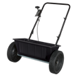 The Sealey Drop Spreader 27kg Walk Behind (SPD27W) is a black, two-wheeled device with a handlebar for pushing and features a rectangular polyethylene dispensing hopper for holding materials.