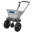 The Sealey Stainless Steel Broadcast Salt Spreader 37kg Walk Behind - SSB37W features a corrosion-resistant design with a gray hopper and black handle, ideal for distributing lawn treatments evenly over large areas. Equipped with pneumatic tires, this tool ensures easy maneuverability.