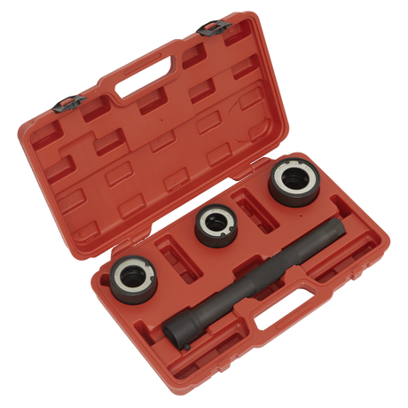 The Sealey Steering Rack Knuckle Tool Set 4pc - VS4003 is an open red plastic case containing four automotive tools, including three metal rings and a cylindrical tool with black handles, all set in custom cutouts inside the case, specifically designed for work on a steering knuckle.