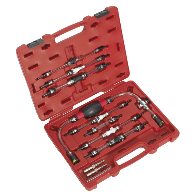 The Diesel Fuel Priming Set - VS555 by Sealey is presented in a red plastic case containing various automotive pressure test adapters, quick connectors, and the fuel priming set itself. All components are arranged neatly in custom slots for organization and protection. The open case displays the tools inside.