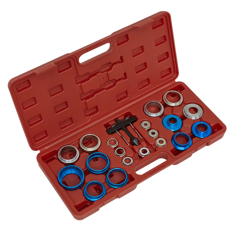 The Sealey Oil Seal Removal/Installation Kit - VS7002 includes a variety of metal bearings, spacers, and a comprehensive oil seal tool, all housed in a red carrying case with a handle for easy transport.