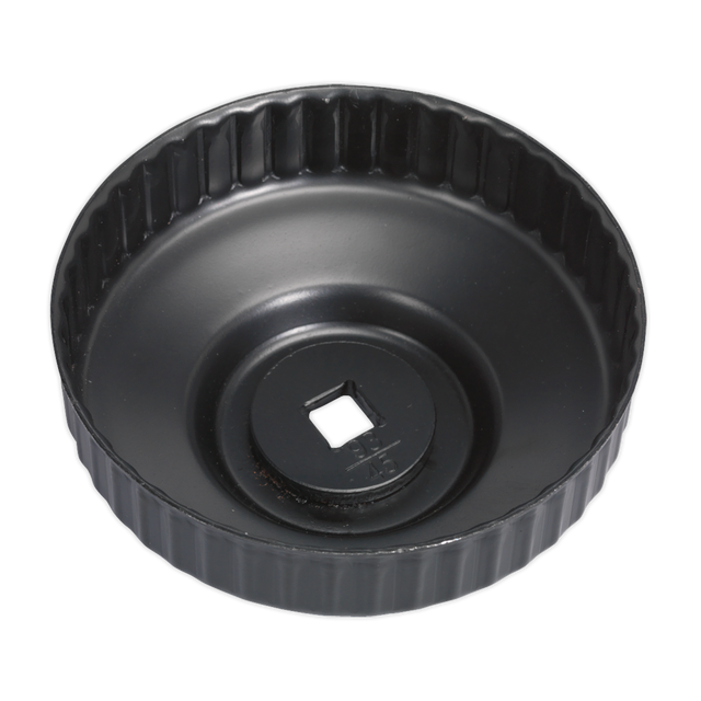 The Sealey Oil Filter Cap Wrench Ø93mm x 45 Flutes - VS7006.V2-22 is a black round wrench with a low profile design, featuring a ridged edge and a central square hole for ratchet tool attachment. Ideal for VW/Audi vehicles, this cap type filter wrench ensures easy and efficient removal or installation.