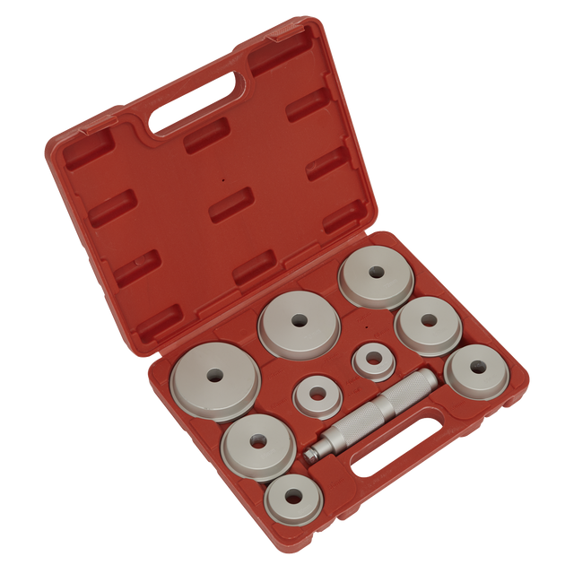 A Sealey Bearing Race & Seal Driver Set, model VS703, comes in a red plastic case with a handle and includes various popular bearing race sizes along with an assortment of circular metal dies and a central cylindrical tool, all neatly arranged in individual compartments.