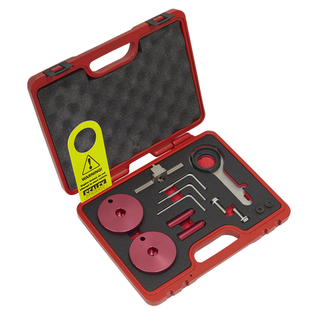 The Sealey Diesel Engine Timing Tool Kit - for Ford 2.0TDCi EcoBlue - Belt Drive (Model VSE5640) includes a red plastic carrying case with foam padding, containing assorted precision tools and components such as red discs, a wrench, and various small metal instruments crucial for diesel engine maintenance. Additionally, a caution tag is attached.