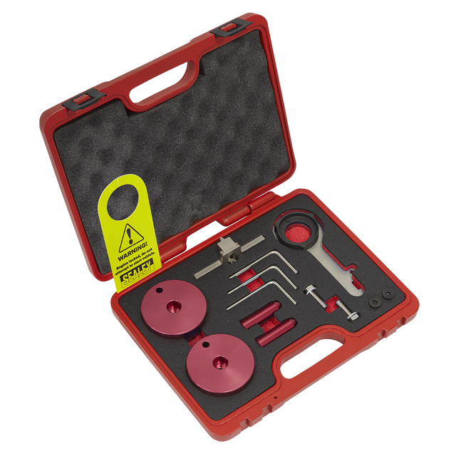 The Sealey Diesel Engine Timing Tool Kit - for Ford 2.0TDCi EcoBlue - Belt Drive (Model VSE5640) includes a red plastic carrying case with foam padding, containing assorted precision tools and components such as red discs, a wrench, and various small metal instruments crucial for diesel engine maintenance. Additionally, a caution tag is attached.