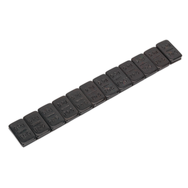 Image of a Sealey Wheel Weight 5g Adhesive Zinc Plated Steel Black Strip of 12 (Pack of 50 - WWSA5B), similar in appearance to a Braille strip with multiple cells and raised dots, designed to adhere securely to alloy rims for use by the visually impaired.