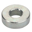 The AGCO | Spacer - Acx2508430 is a sturdy metallic flat washer with a central hole, designed to distribute the load of a threaded fastener effectively.