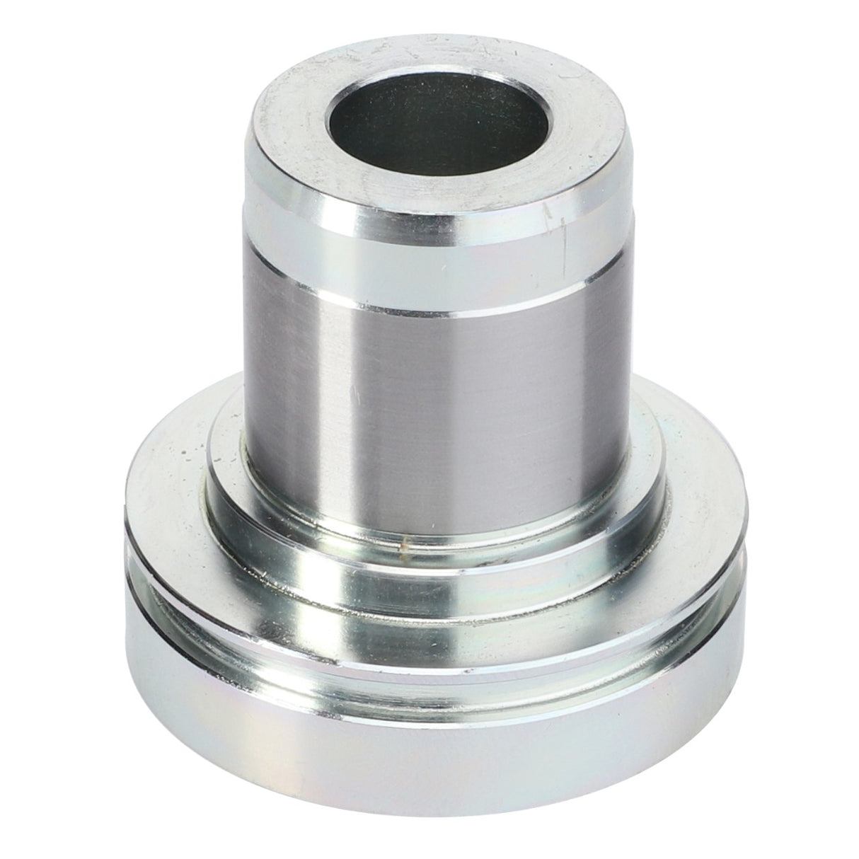 The AGCO Bearing Bushing - 931502200050 is a cylindrical metal part with a larger base, featuring a central hole and a smooth, shiny surface, commonly used as bushings in Fendt models.