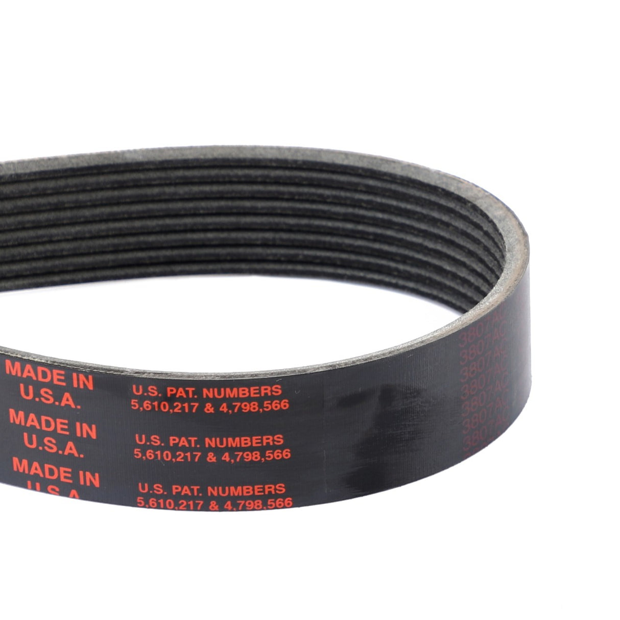 Close-up of the AGCO Genuine Serpentine Belt, Pk8 Profile - A3288911V, featuring a black ribbed design with red text indicating it is made in the USA and listing US patent numbers 5,610,217 and 4,798,566. This belt is engineered to enhance engine performance while minimizing noise and slippage.