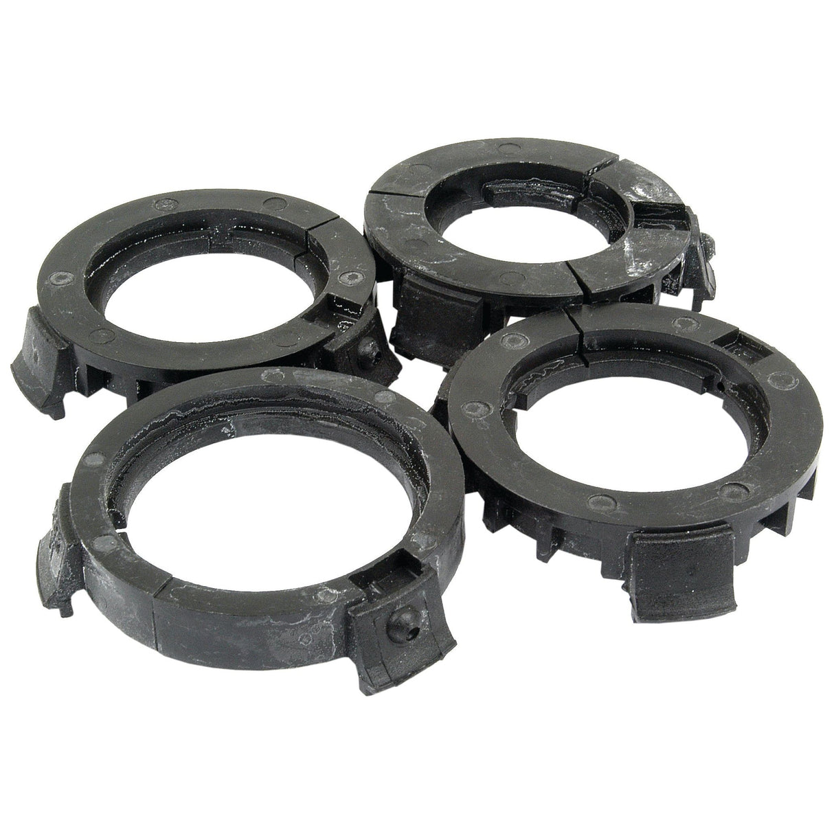 Four black plastic washer guides with grooves, distinctly arranged in a cluster on a white background, provide an efficient solution akin to Sparex PAK-PTO Bearings Eco-Small (Sparex Part No. S.10470).