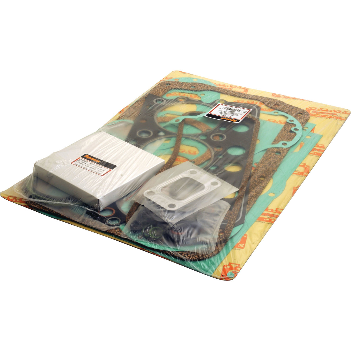 A sealed package labeled with Sparex branding, containing the Complete Gasket Set (311C, CS) – Sparex Part No.S.110928 and various small parts, is visible through a clear plastic wrap and placed on a cardboard backing.