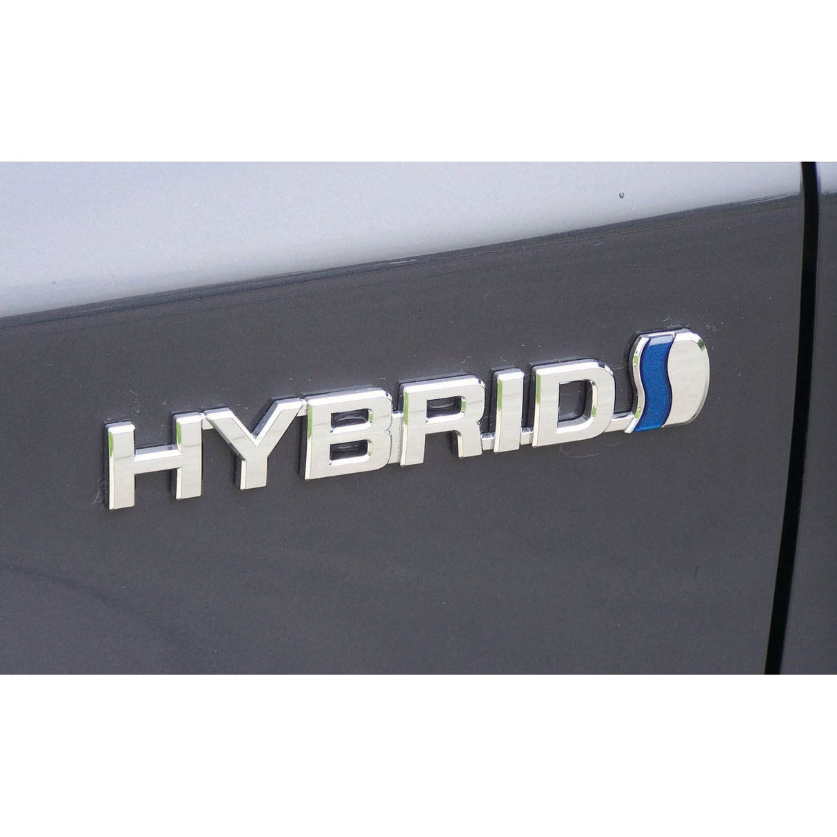 Close-up of a car's exterior showing the word "HYBRID" in metallic letters with a blue and silver emblem next to it, reminiscent of the precision found in the Sparex Electrical Voltage Tester - S.151758.
