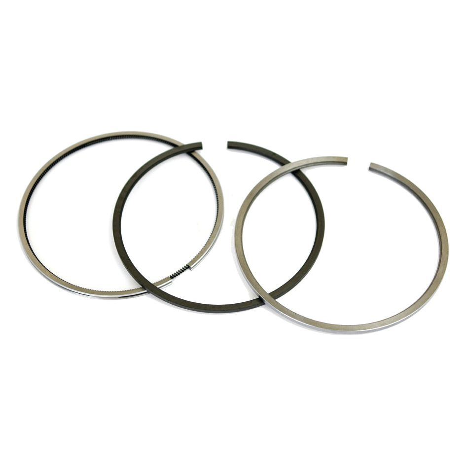 Three piston rings from the Sparex Piston Ring Set (Sparex Part No. S.30056), arranged side by side on a white background. One ring, part of the chrome-plated set, has slight grooves along its edge. The rings vary slightly in thickness.