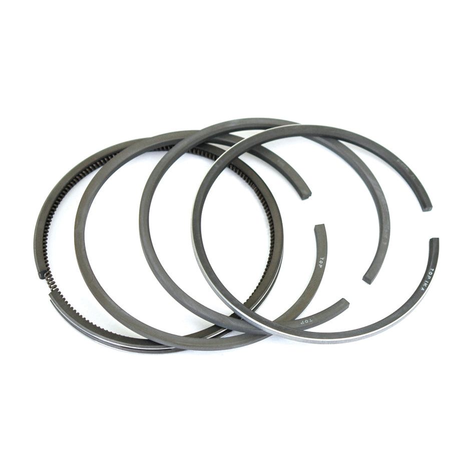 Close-up of four Sparex Piston Ring | Sparex Part No. S.62335, arranged in an overlapping manner on a white background. This ring set is perfect for your Fiat 411R.