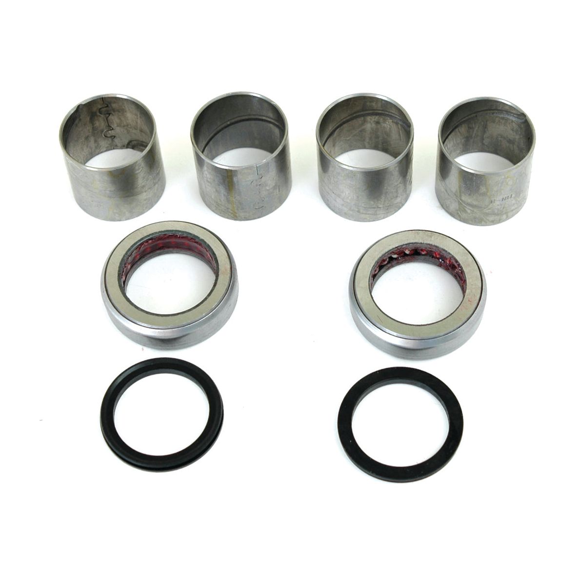 Four cylindrical metal sleeves from the Sparex Spindle Repair Kit (Part No. S.65111), two Ford / New Holland rings with red interiors, and two black circular rings marked 65118 are meticulously arranged in rows on a white background.