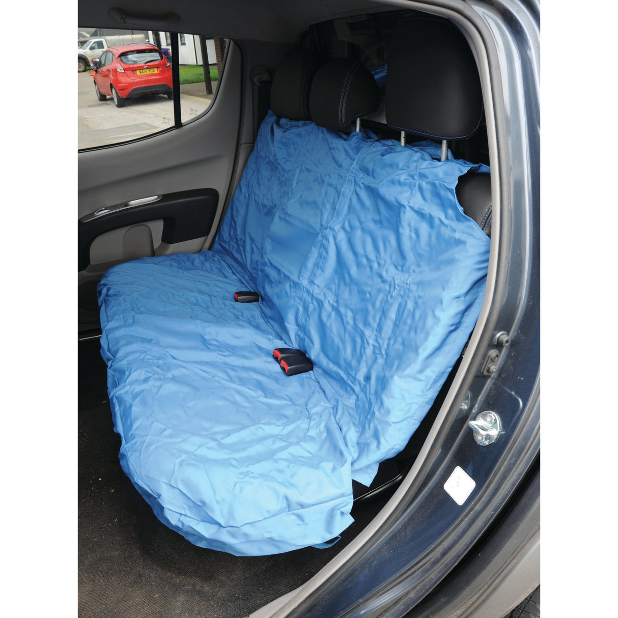 The large rear seat is covered with the Sparex Rear Van Seat Cover - Car & Van - Universal Fit - S.71863, a blue, waterproof protective cover, with the seat belts visible on top.