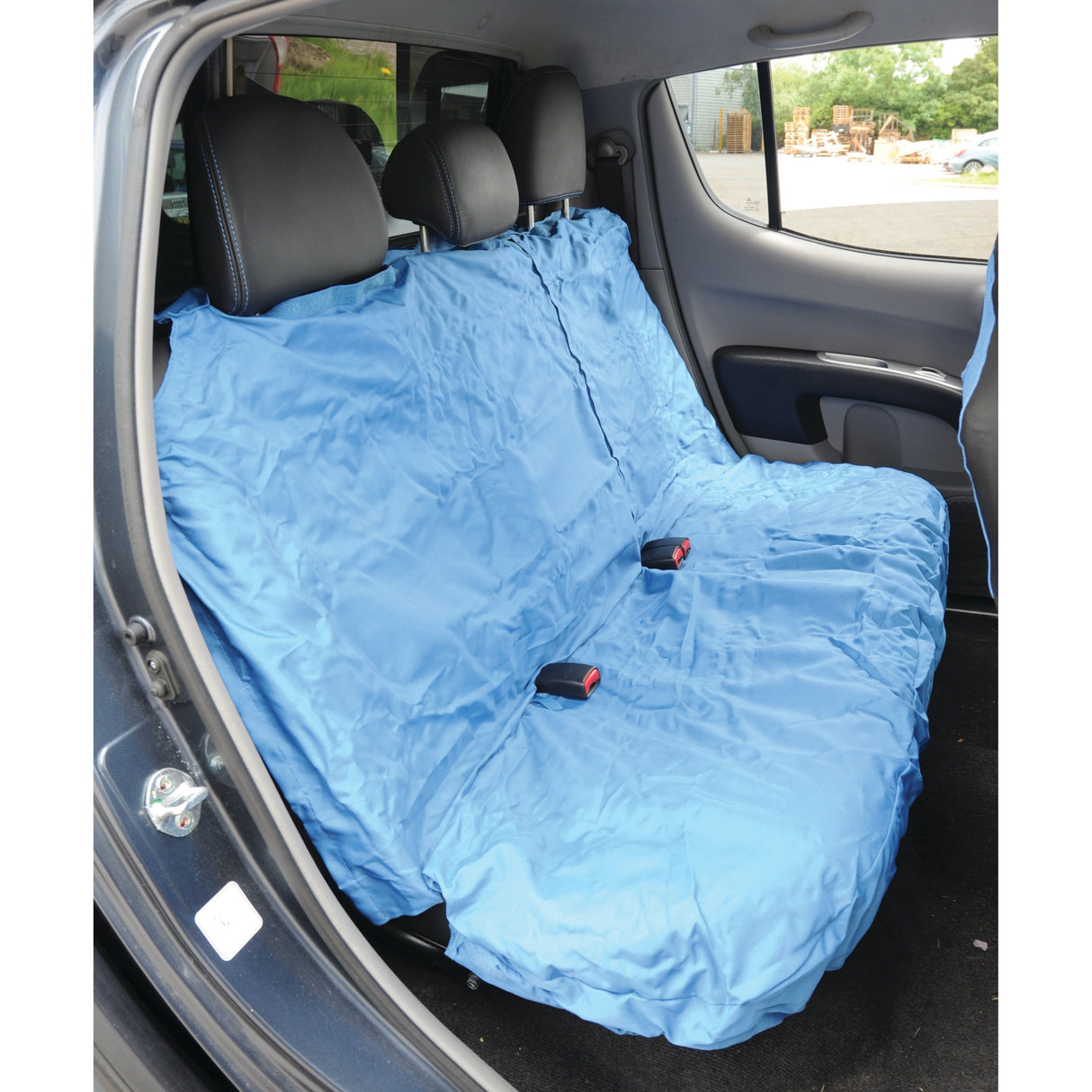 A car's rear seat fitted with the Sparex Rear Van Seat Cover - Car & Van - Universal Fit (S.71863), which is large, blue, waterproof, and has accessible slits for seat belts.