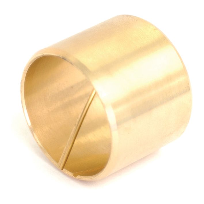 A cylindrical brass bushing with a smooth exterior and a slit on one side, suitable for Case IH Spindle Bush applications, known as the Spindle Bush | Sparex Part No. S.7775 by Sparex.