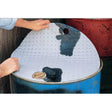A person placing a Sparex ABSORBENT PAD-DRUM TOP (5) - S.20463 on top of a blue 205-litre drum to soak up spilled liquid.