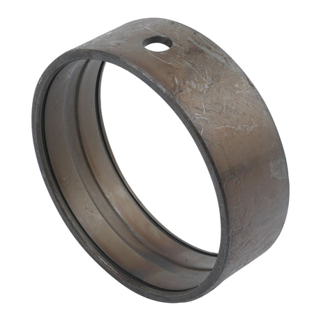A Spindle Bush, Sparex Part No.S.7721, made of metal and cylindrical in shape, resembles a ring with a single small hole near the top and visible surface wear.