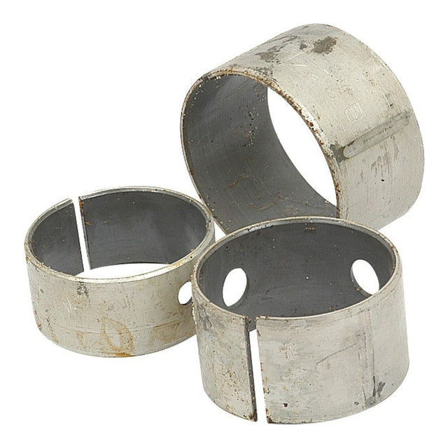 Three worn, cylindrical metal sleeves with splits and holes, likely mechanical components from the Camshaft Bush Kit (Engine Model S.57369) by Sparex, are arranged on a white background.