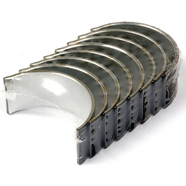 A set of Conrod Bearings +0.010'' (0.25mm) Set (Sparex Part No.S.42360) stacked together in an arching formation on a white background, showcasing the quality you expect from Sparex.