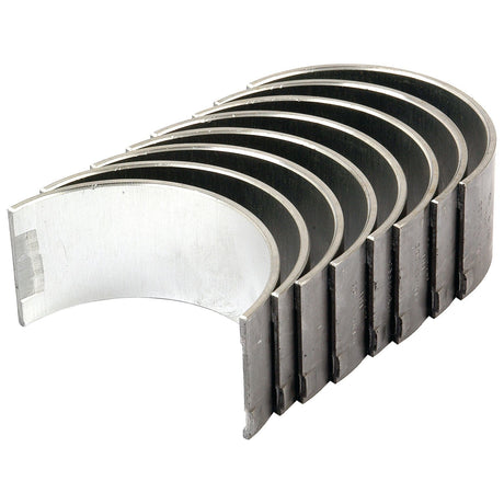 A set of seven silver-colored metal semi-circular Conrod Bearings +0.010'' (0.25mm) from Sparex, bearing the part number S.57644, evocative of those used in Case IH and International Harvester machinery, arranged in a fanned-out formation.